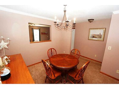 Dining Room. A graceful wrought iron chandelier re