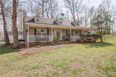 Mature landscaping, front porch runs entire length of home.
