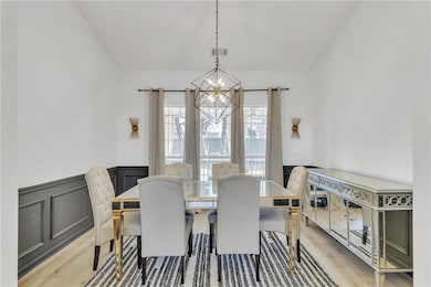 Dining space with a wainscoted wall, a notable cha