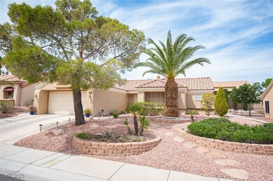 View of front of home featuring concrete driveway, a tiled roof, a garage, and stucco siding
