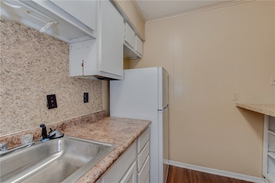 Kitchen with freestanding refrigerator, light coun