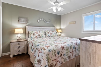 Bedroom featuring baseboards, dark wood-style floo