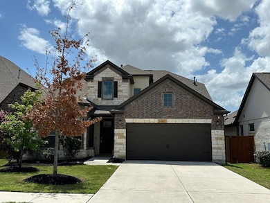 French country style house with stone siding, dri