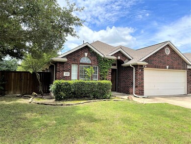 View of front facade with a garage and a front lawn