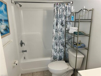 Bathroom with shower / bath combination with curtain and tile patterned flooring