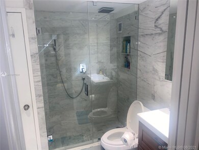Stone bathroom with washer/dryer area