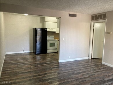 Kitchen featuring white cabinets, white range with