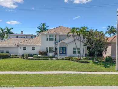 Traditional home featuring a tile roof, a front la