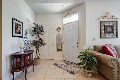 Foyer entrance with light tile patterned floors and a textured ceiling