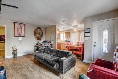 Living room featuring light wood-style floors, bas