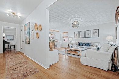 Living room featuring a chandelier and light wood-type flooring