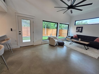 Living area featuring finished concrete floors, h