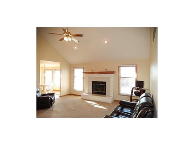 Wood fireplace. Vaulted ceiling. Opens to the kitc