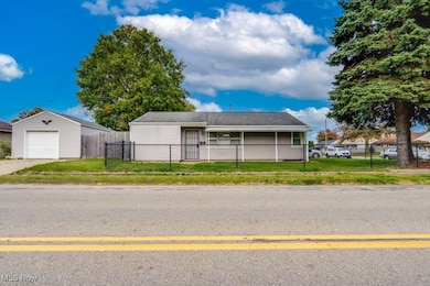 View of front facade with a fenced front yard and a detached garage