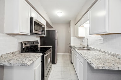 Kitchen with cabinets, countertop and appliances