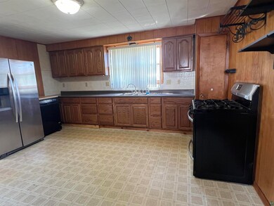Kitchen featuring black appliances and sink