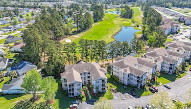 Aerial view featuring a water view, view of golf c