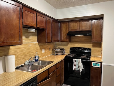 Kitchen featuring sink, decorative backsplash, bla