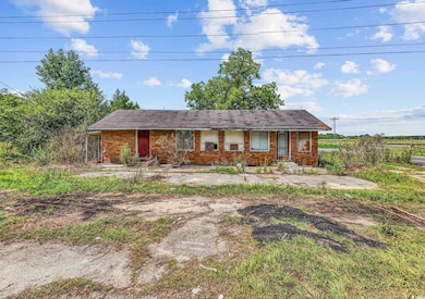 Ranch-style house featuring brick siding