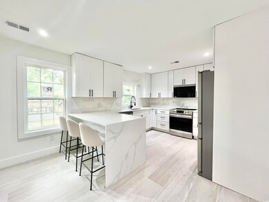 Kitchen featuring a breakfast bar area, appliances