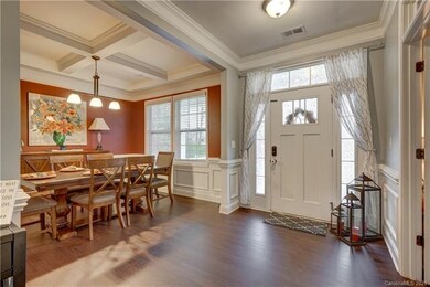 Elegant entry way, grand crown molding, and open floor plan