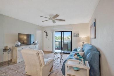Tiled living room featuring ceiling fan