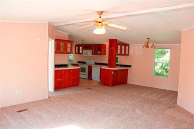 View of open living room/dining area to kitchen as