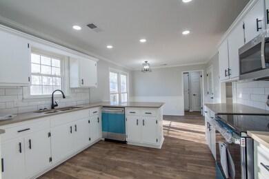 Kitchen featuring sink, dark hardwood / wood-style