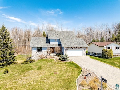 Traditional home with stone siding, a garage, deco