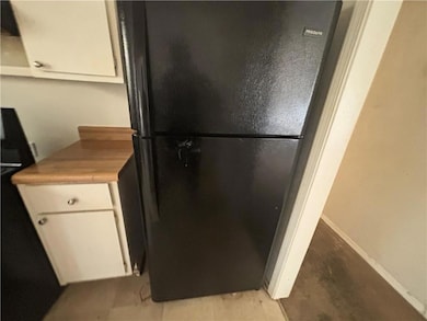 Kitchen with light countertops, freestanding refri