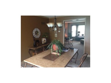 Dining room next to kitchen, looks out at pool and