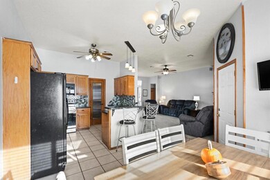 Tiled dining area with ceiling fan with notable ch