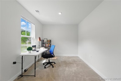 Carpeted office featuring baseboards