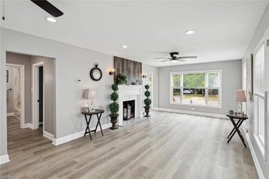 Hardwood floored living room with ceiling fan