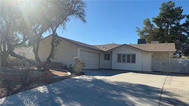 View of front of house with concrete driveway and a garage