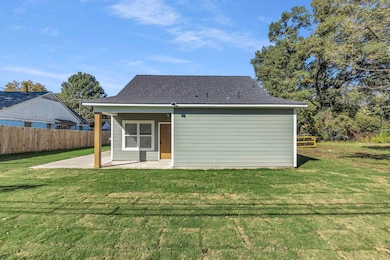 Back of property featuring a patio area and roof with shingles
