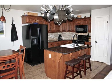 Kitchen. Kitchen has granite counters, island with new double porcelain sink, and gas range.