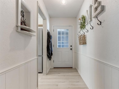 Doorway to outside featuring light wood finished f