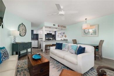 Living area featuring wood finished floors, ceiling fan, and baseboards