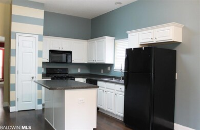 Kitchen with pretty white cabinets and a gas stove