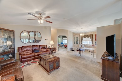 Living room with lofted ceiling, light colored car