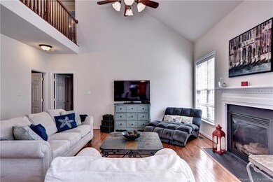 Spacious Great Room with hardwood floors, vaulted ceiling and gas fireplace.