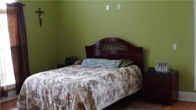 Main level master bedroom with hardwood floors, walk-in closet, and full bath. 