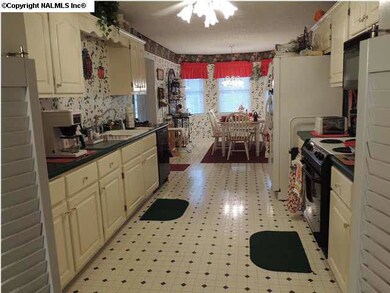 Huge kitchen with eat-in area and gleaming white cabinets give you plenty of room for planning holiday meals.