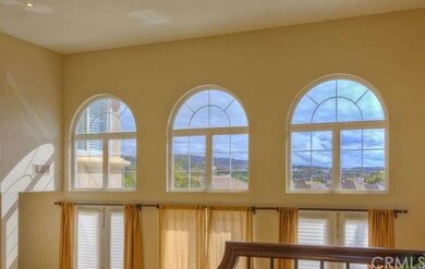 Dramatic living room floods with light and a view
