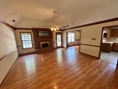 Unfurnished living room featuring a fireplace, a h