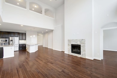 Unfurnished living room featuring a high ceiling,
