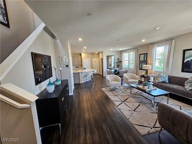 Living room featuring dark wood-style floors, rece