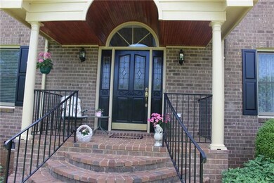 Brick paved front porch with grand overhead Arch w