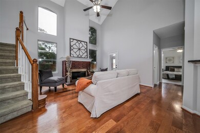 Living area with high ceilings, fireplace, gorgeous flooring and tall windows!